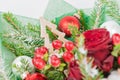 Close-up of decorative Christmas tree in a bouquet of red rose, Royalty Free Stock Photo