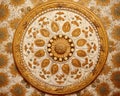 close up of a decorative design on a wallpapered surface with a circular design in the center.