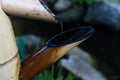 Close-up on decorative japanese bamboo fountain catching dripping water Royalty Free Stock Photo