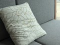 Close-up of Decorative Leaf Pattern Pillow on Grey Sofa Royalty Free Stock Photo