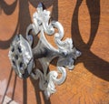 Close up decorative old metal fitting on ancient medieval brown wooden door