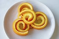 Decorative orange peels on white plate