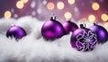 Close up of decorative purple baubles on white fur. Royalty Free Stock Photo