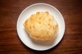 Close-up of deep fried bhature maida puri made from all purpose flour, served hot in white ceramic plate.