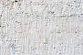 Close-up Deep texture of white-painted porous stone on the facade of the building. Stoned wall background texture Royalty Free Stock Photo