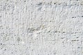 Close-up Deep texture of white-painted porous stone on the facade of the building. Stoned wall background texture Royalty Free Stock Photo