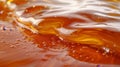 Close up of delicate liquid caramel swirl with smooth lines as background texture
