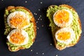 Close-up of delicious avocado toast topped with sliced boiled eggs and sesame seeds