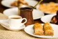 Close up of a delicious breakfast of traditional turkish food baklava with pistachio and a white cup of coffe