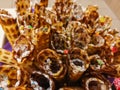 Close-up of delicious chocolate waffle rolls lie on white plate. Preparation of a sweet dessert. White clean kitchen and table. Royalty Free Stock Photo