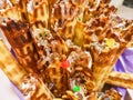 Close-up of delicious chocolate waffle rolls lie on white plate. Preparation of a sweet dessert. White clean kitchen and table. Royalty Free Stock Photo