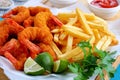 Breaded Fried Shrimps, limes and french fries Royalty Free Stock Photo