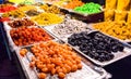 Close-up of delicious dried fruits neatly displayed on wholesale market trays. Merchants sell dried fruits in Asia