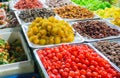 Close-up of delicious dried fruits neatly displayed on wholesale market trays. Merchants sell dried fruits in Asia