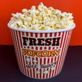 Close up delicious fresh buttery popcorn in a stripped red and white bowl Royalty Free Stock Photo