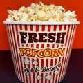 Close up delicious fresh buttery popcorn in a stripped red and white bowl Royalty Free Stock Photo