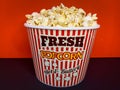 Close up delicious fresh buttery popcorn in a stripped red and white bowl Royalty Free Stock Photo