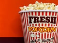 Close up delicious fresh buttery popcorn in a stripped red and white bowl Royalty Free Stock Photo