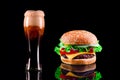 Close-up of delicious fresh home made burger with lettuce, cheese, onion, tomato and cola drink or dark beer with ice on