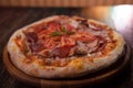 Delicious hot pizza on a wooden table Royalty Free Stock Photo