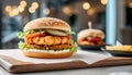 Close-up of delicious fresh tasty chicken burger on table. Cafe interior. Tasty fast food Royalty Free Stock Photo