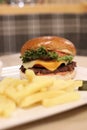 Close-up of delicious hamburger and french fries served on a white plate Royalty Free Stock Photo