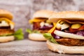 Close up of Delicious home made burgers on wooden plate Royalty Free Stock Photo