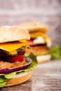 Close up of Delicious home made burgers on wooden plate Royalty Free Stock Photo