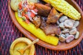 Close up of delicious hornado, ecuadorian traditional typical andean food served with corn, potato, salad, plantain and