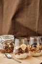 Close up of delicious layered dessert in glass jar, Homemade yogurt with granola and berries, Granola baked with nuts Royalty Free Stock Photo