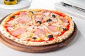 Close up Delicious Meat Pizza with bacon, chicken fillet, sliced mushrooms and olives on the wooden board on the s Royalty Free Stock Photo