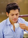 Close up of a delicious mediterranean breakfast, hot man drinking a cup of chocolate on brown background Royalty Free Stock Photo