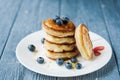 Close-up delicious pancakes, with fresh blueberries and maple syrup on a light background. With copy space. Sweet maple syrup Royalty Free Stock Photo