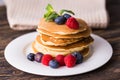 Close-up delicious pancakes with fresh blueberries and raspberries.