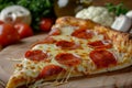 Close up of delicious pepperoni pizza slice over wooden table