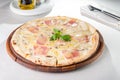 Close up Delicious Pizza with bacon, sliced mushrooms and cream cheese on the wooden board on the served restauran Royalty Free Stock Photo