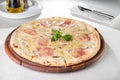 Close up Delicious Pizza with bacon, sliced mushrooms and cream cheese on the wooden board on the served restauran Royalty Free Stock Photo