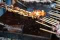 close up of delicious satay grilled squid, for sale in street food