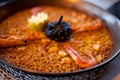 Close-up of delicious seafood valencia paella with king prawns, rice with spices and lemon wedges in pan, view from Royalty Free Stock Photo