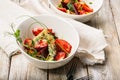 Close-up delicious summer salad. Salad with fresh strawberries, baked beets, yellow tomatoes, dor blue cheese and herbs in a white Royalty Free Stock Photo