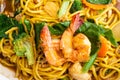 Close up delicious yellow fried noodles with soy sauce, prawns, vegetables and mushrooms. Thai stir-fried noodles Pad See-Ew. To