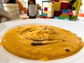 Close-up of delicious yellow pumpkin soup seasoned with vinegar sauce