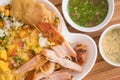 Close up of delicous hornado with mashed potatoes with salad, tostado and mote with two smalls bowls with green and pink