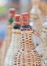 Close up of demijohn bottles with corn cob plug at souvenir market in Romania