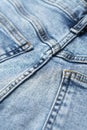 Close-up of denim blue fabric with pockets and yellow seams Royalty Free Stock Photo