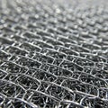 Close-up of a densely woven metal wire mesh. The intricate pattern involves Royalty Free Stock Photo