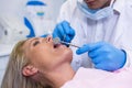 Dentist examining young woman at medical clinic Royalty Free Stock Photo