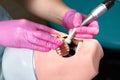 Close-up of dentist hands who is learning to treat teeth on mannequin of human head. Hands of a medical student in Royalty Free Stock Photo