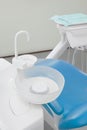 Close up Dentist\'s office interior with blue chair and special dentist equipment