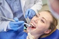 Close up of dentist treating female patient teeth Royalty Free Stock Photo